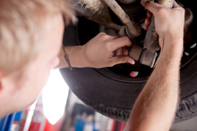 Mechanic Fixing Brakes